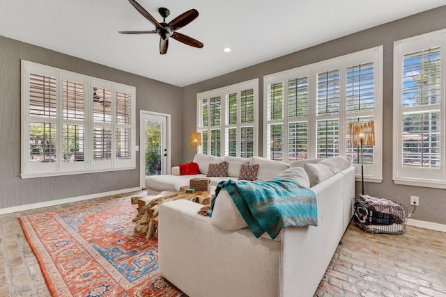 living room with brick floor, plenty of natural light, and baseboards