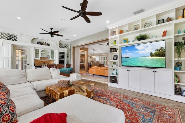 living area featuring recessed lighting, wood finished floors, and visible vents