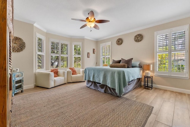 bedroom featuring multiple windows, baseboards, and wood finished floors