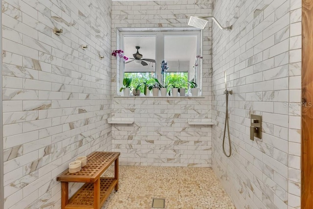 full bathroom featuring a tile shower and ceiling fan