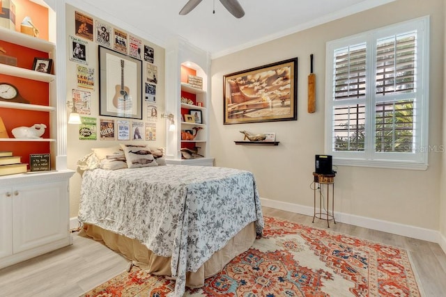 bedroom with light wood-style flooring, a ceiling fan, baseboards, and ornamental molding