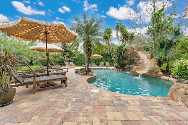 outdoor pool with a patio and a water slide