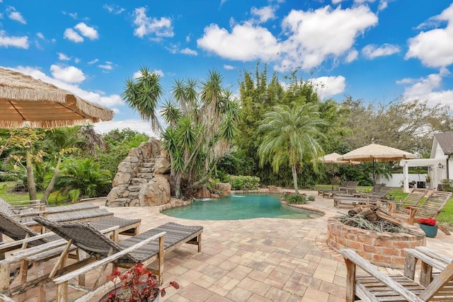 pool featuring a patio area and a fire pit