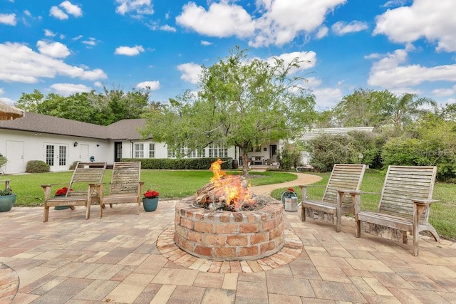 view of patio / terrace featuring french doors and an outdoor fire pit