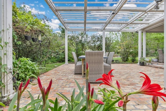 view of patio featuring outdoor dining space and a pergola