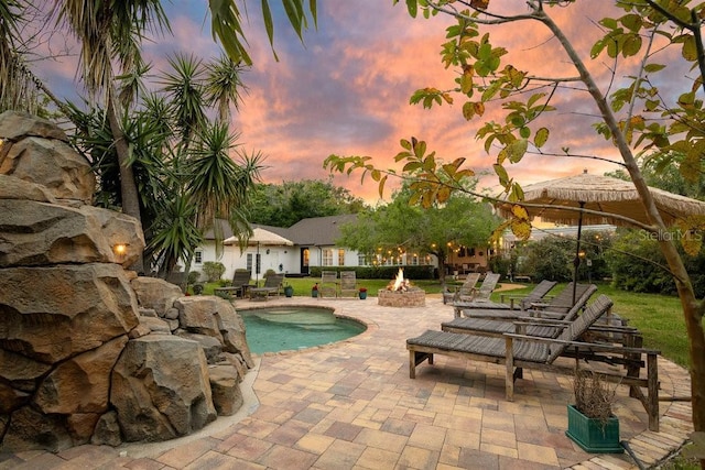 view of pool with a patio and an outdoor fire pit