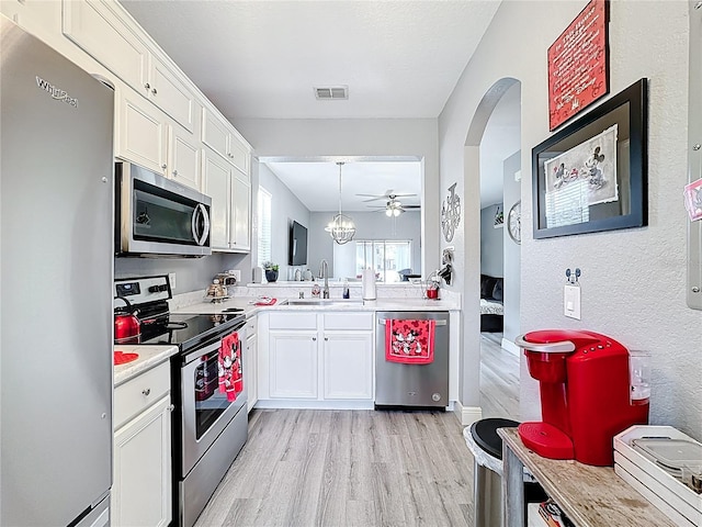 kitchen with visible vents, appliances with stainless steel finishes, light countertops, light wood-type flooring, and a sink