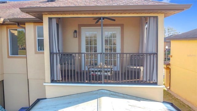 view of exterior entry with a shingled roof, ceiling fan, and stucco siding