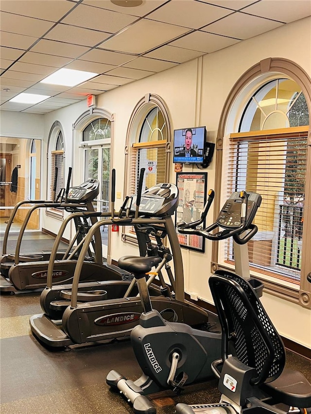 gym with a paneled ceiling