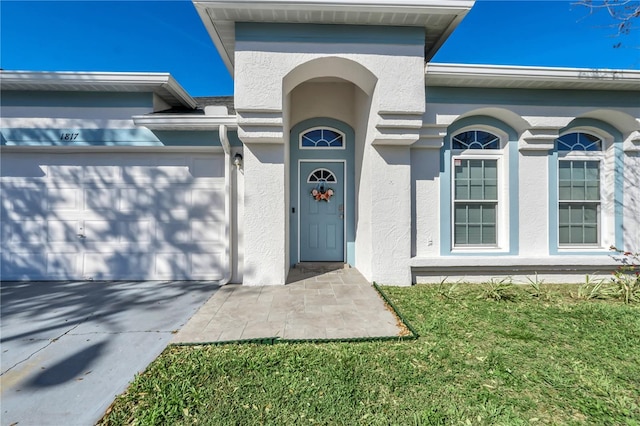 property entrance featuring stucco siding and a garage