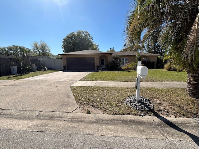 single story home with stucco siding, driveway, fence, a front yard, and a garage