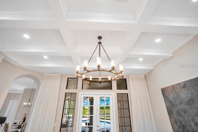 interior details with recessed lighting, arched walkways, french doors, crown molding, and a chandelier