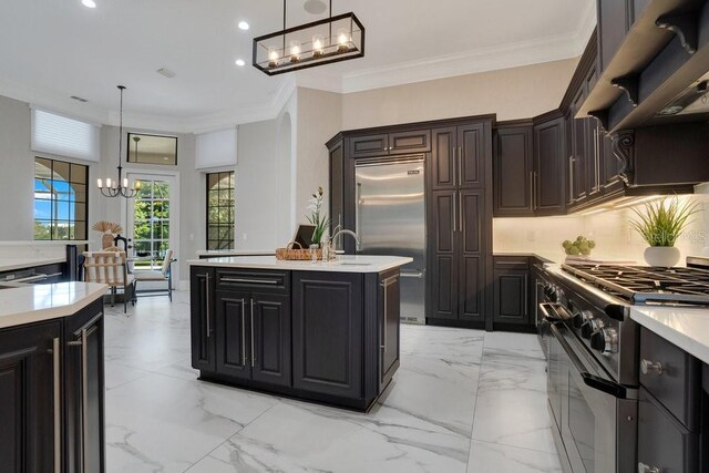 kitchen with marble finish floor, high end appliances, a kitchen island with sink, and light countertops