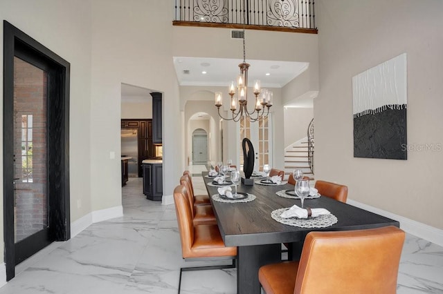 dining space featuring visible vents, baseboards, marble finish floor, and arched walkways