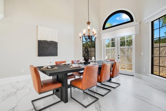 dining area featuring french doors, baseboards, and marble finish floor