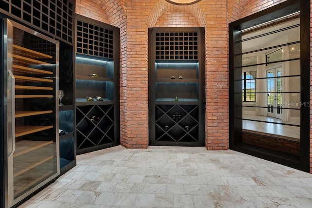 wine area with brick wall and stone finish flooring