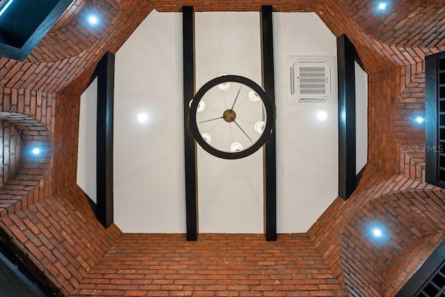 hall with brick floor and vaulted ceiling