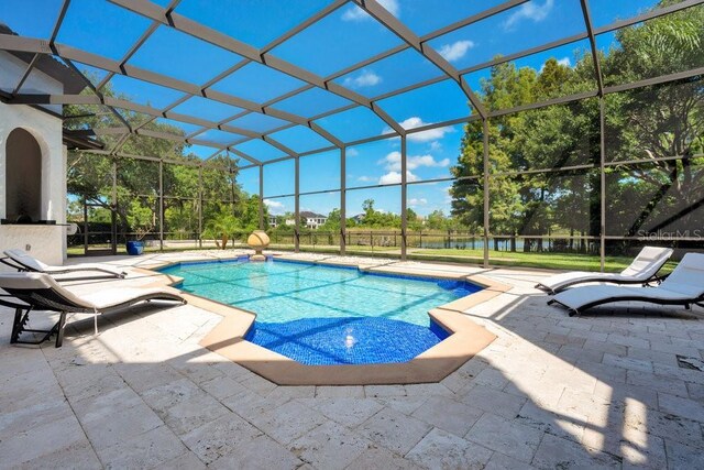 outdoor pool with glass enclosure and a patio