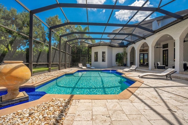 outdoor pool with a lanai, french doors, and a patio