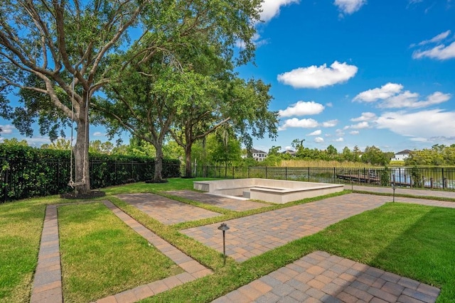 view of community with a yard and fence