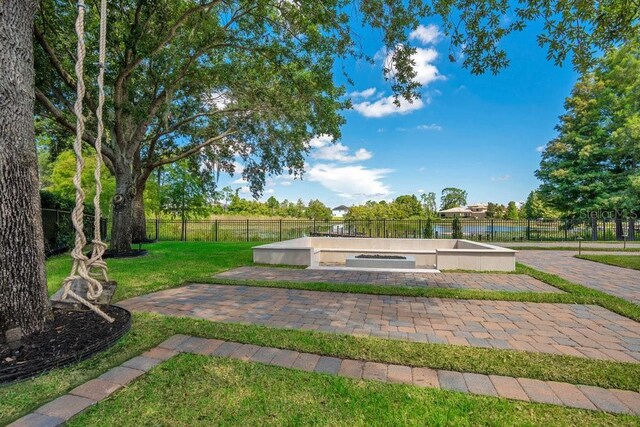 view of community with a lawn and fence