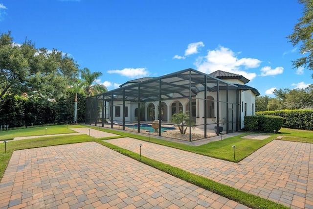 exterior space featuring a yard, a swimming pool, and a patio area