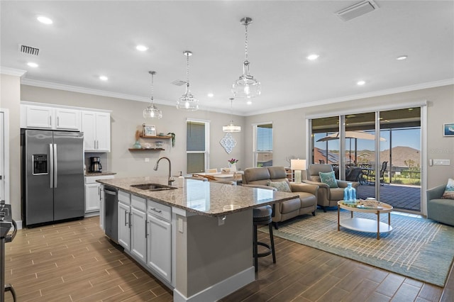 kitchen featuring a sink, open floor plan, visible vents, and stainless steel appliances