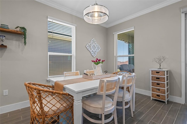 dining space with ornamental molding, baseboards, and wood finish floors