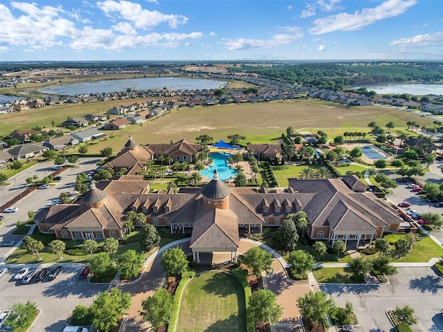 drone / aerial view featuring a residential view and a water view