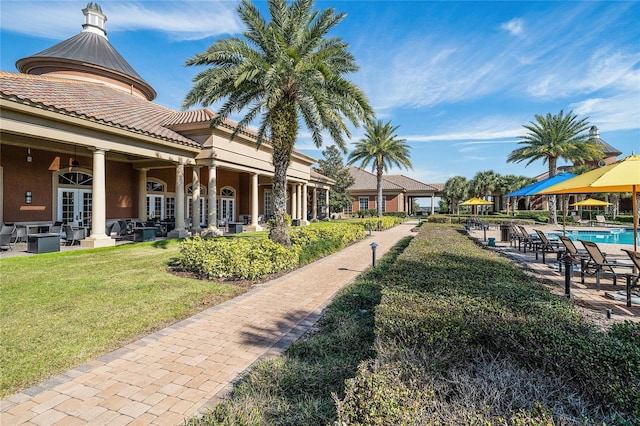 surrounding community featuring a yard, a pool, and a patio