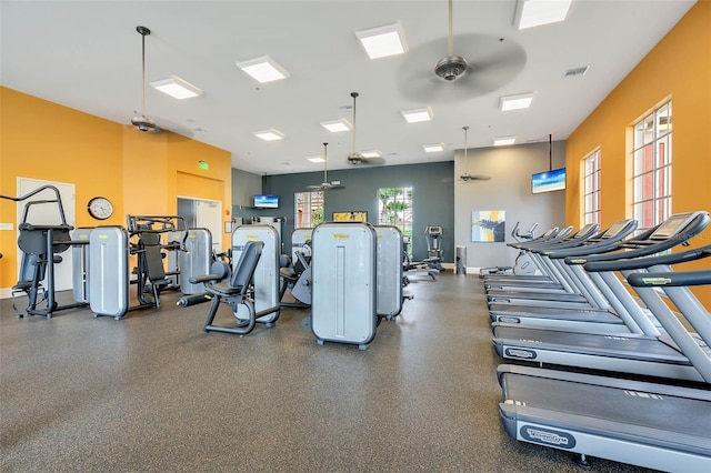 gym featuring a ceiling fan, baseboards, and visible vents