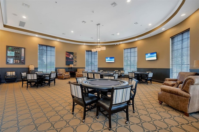 dining space with recessed lighting, a tray ceiling, visible vents, and wainscoting