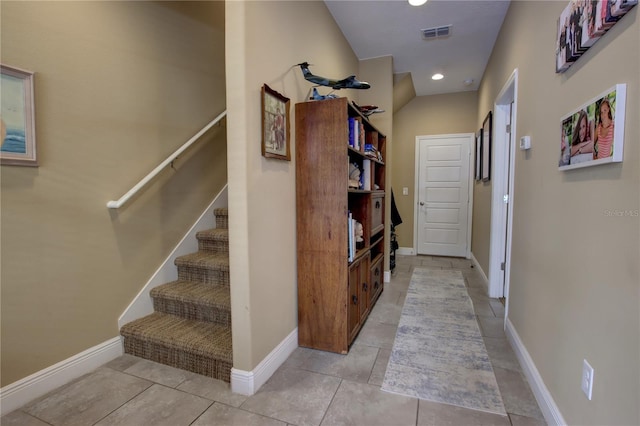 hall with light tile patterned floors, baseboards, visible vents, and recessed lighting