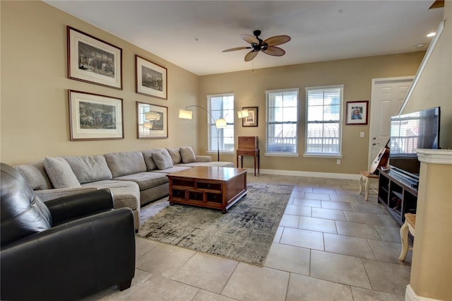 living room with light tile patterned floors, baseboards, and a ceiling fan