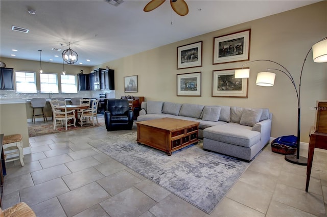 living room with a ceiling fan, recessed lighting, visible vents, and light tile patterned floors