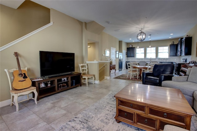 living area featuring a chandelier, recessed lighting, baseboards, and light tile patterned floors