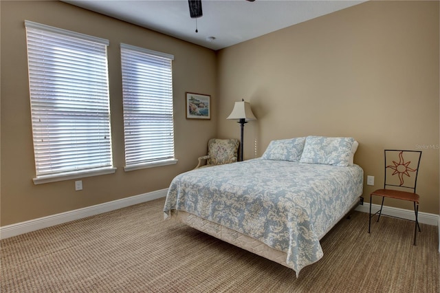 bedroom with a ceiling fan, carpet, and baseboards