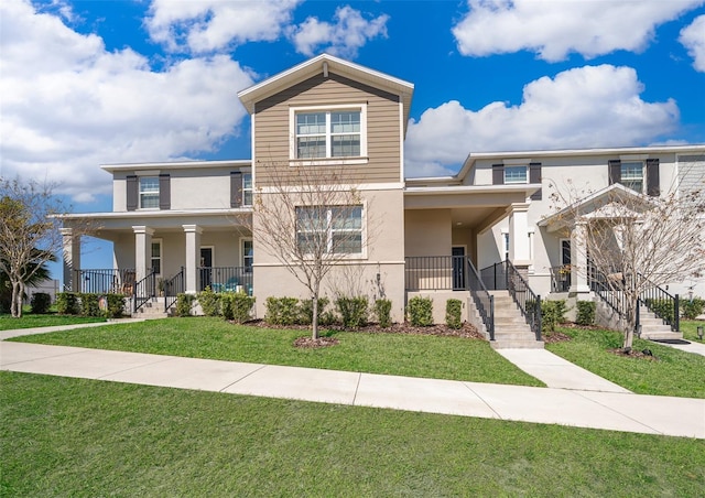 view of front of property featuring a front yard and stucco siding