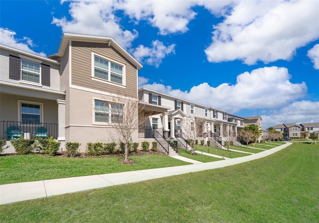 exterior space with a residential view and a lawn