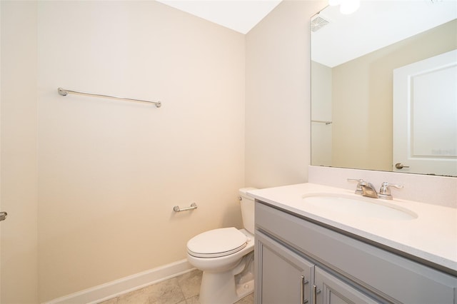 bathroom featuring visible vents, toilet, vanity, tile patterned flooring, and baseboards