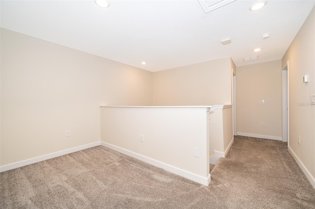 empty room featuring carpet floors, recessed lighting, visible vents, and baseboards