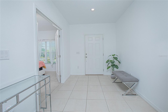 foyer entrance featuring light tile patterned floors, recessed lighting, and baseboards