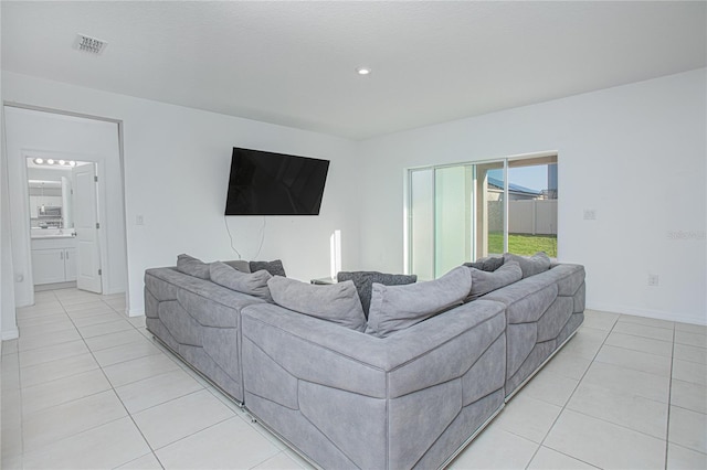 living room featuring visible vents, baseboards, and light tile patterned flooring