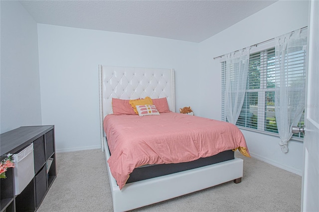 carpeted bedroom with baseboards and a textured ceiling