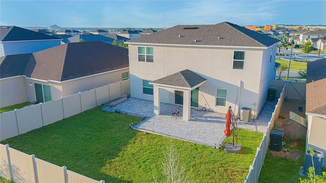 back of house with stucco siding, central AC, a fenced backyard, a residential view, and a patio area