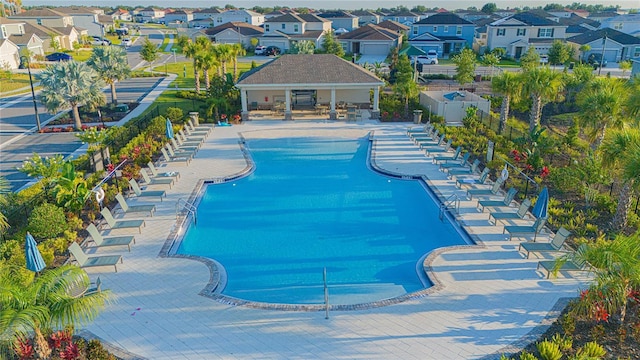 view of swimming pool featuring a residential view and fence