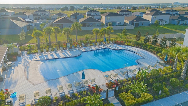 community pool with a residential view and fence