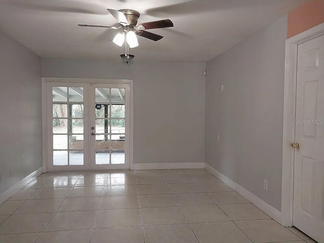 spare room featuring light tile patterned floors, french doors, baseboards, and ceiling fan