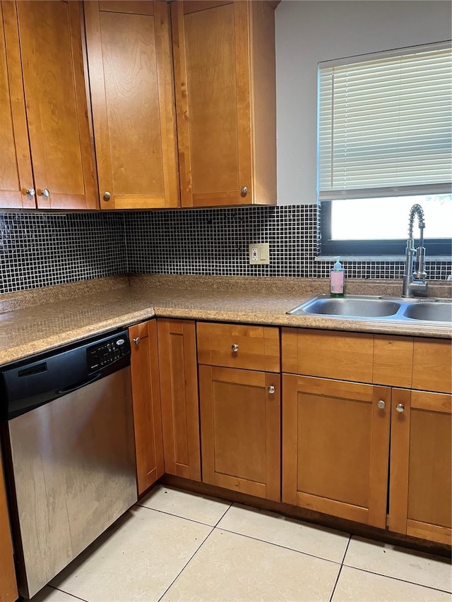 kitchen with dishwasher, light tile patterned floors, backsplash, and a sink