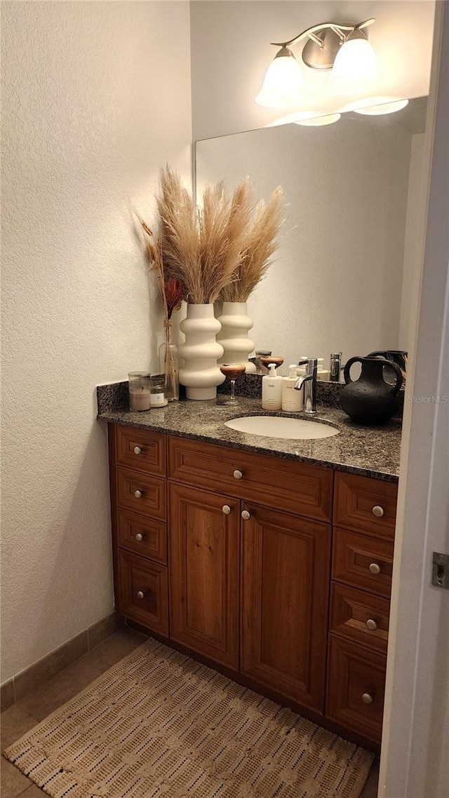 bathroom featuring vanity and baseboards